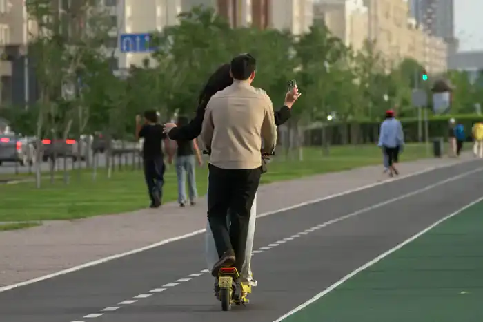 вдвоём на одном самокате, оба без шлемов и один даже не держится, а снимает видеоселфи прямо в процессе